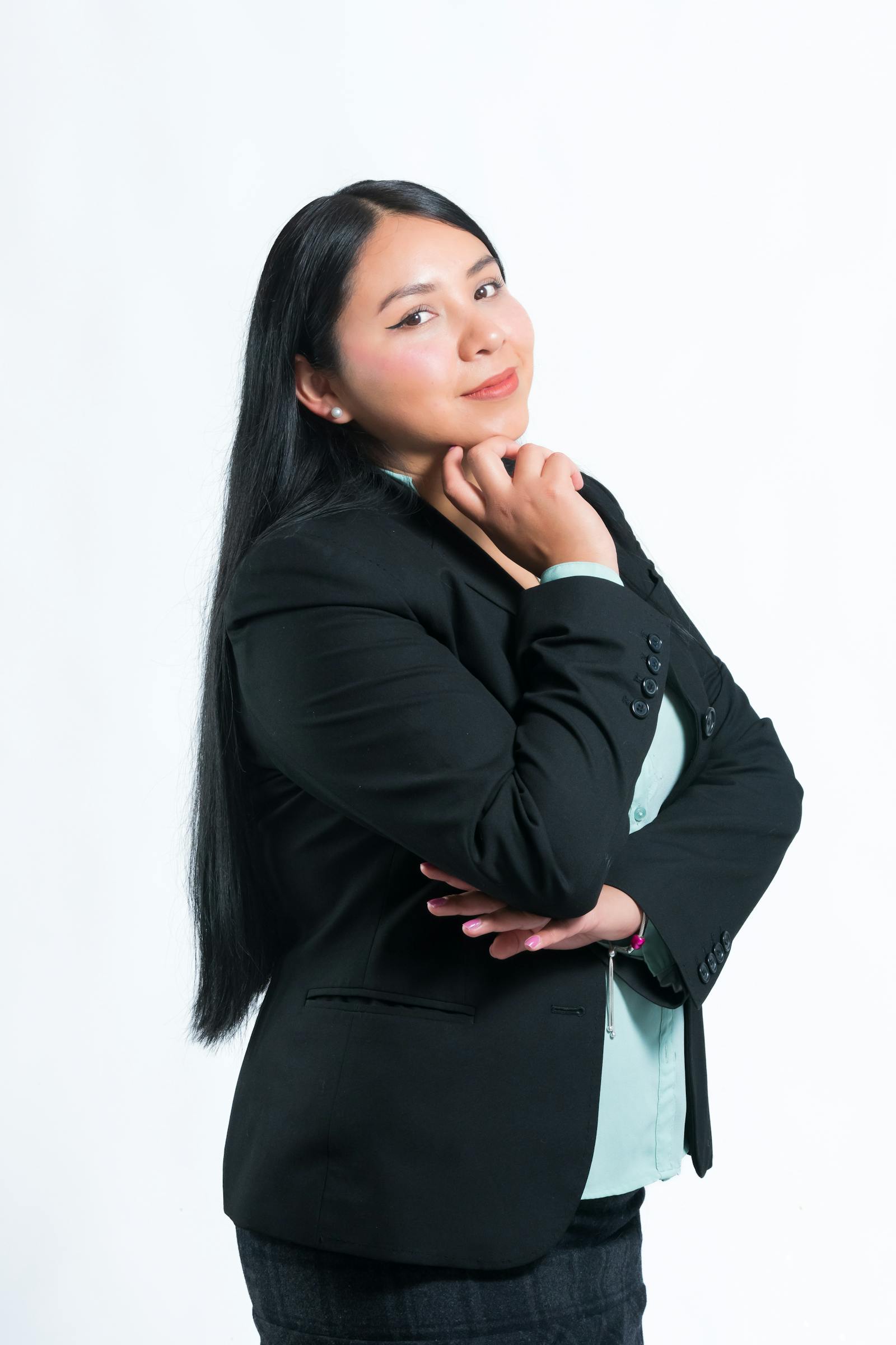Studio portrait of Mira Halden, founder of JAMES VISUAL, in a navy linen overshirt.